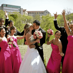 Bride and Groom Kissing Surrounded by Bridal Party