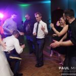 bride, groom, and guests dancing at a wedding