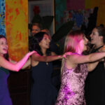 Guests participating in a conga line, dancing to music provided by Paul Michaels Events DJ Company, at Carnivale in Chicago, Illinois