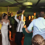 Bride and groom surrounded by loved ones, dancing the night away on the dance floor, with music provided by DJ Paul Michaels from Paul Michaels Events