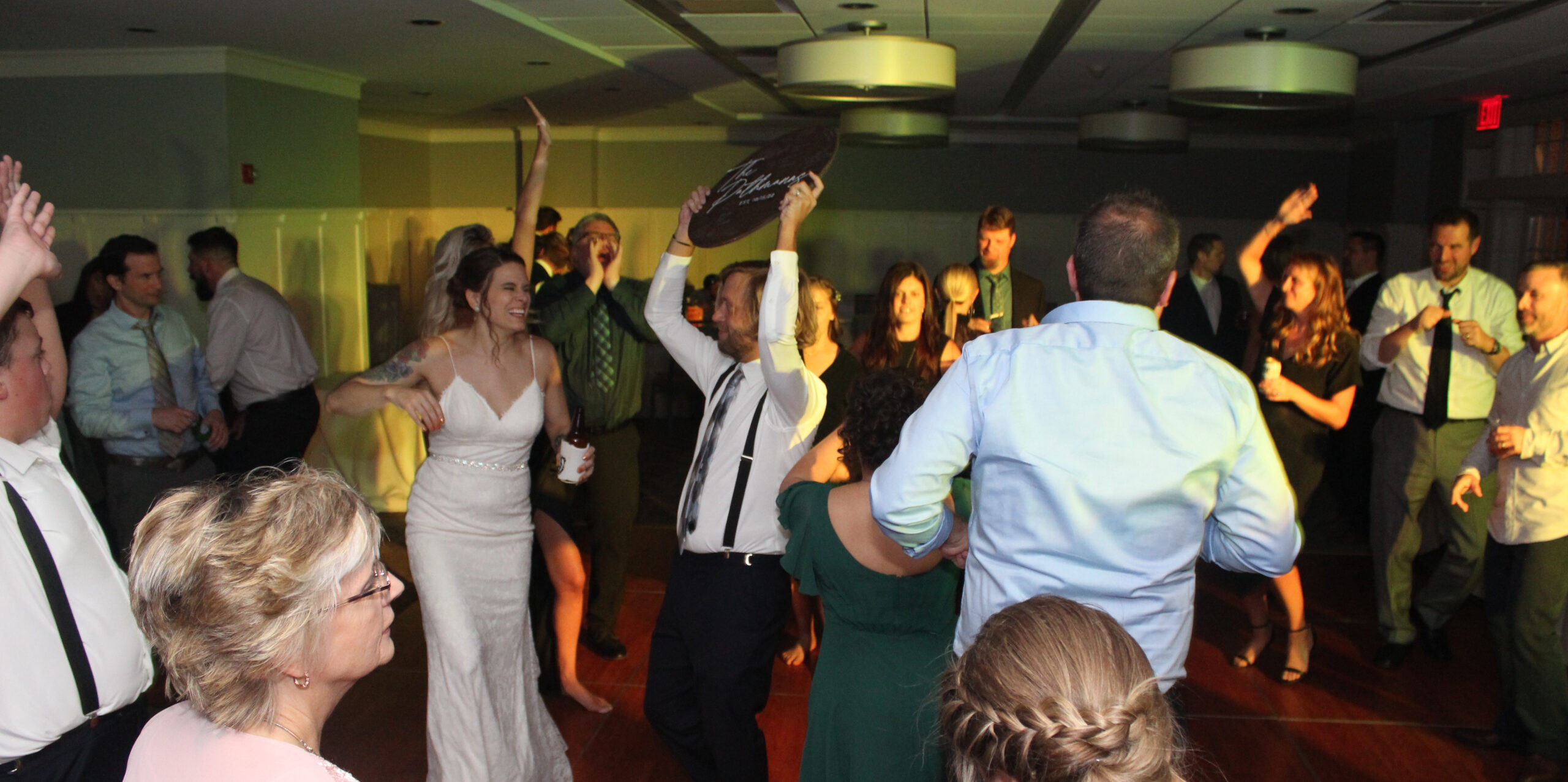 Bride and groom surrounded by loved ones, dancing the night away on the dance floor, with music provided by DJ Paul Michaels from Paul Michaels Events