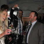 Bride and her guests laughing and dancing with streamers in the air; Downtown Chicago Wedding DJ by Paul Michaels