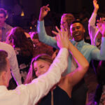 Guests on the dance floor with hands up in the air, dancing to wedding DJ services Chicagoland by Paul Michaels Events