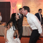 Bride and groom shouting to each other on the dance floor, dancing and singing along to music by Paul Michaels Events DJ Company, the best wedding DJ in Chicagoland