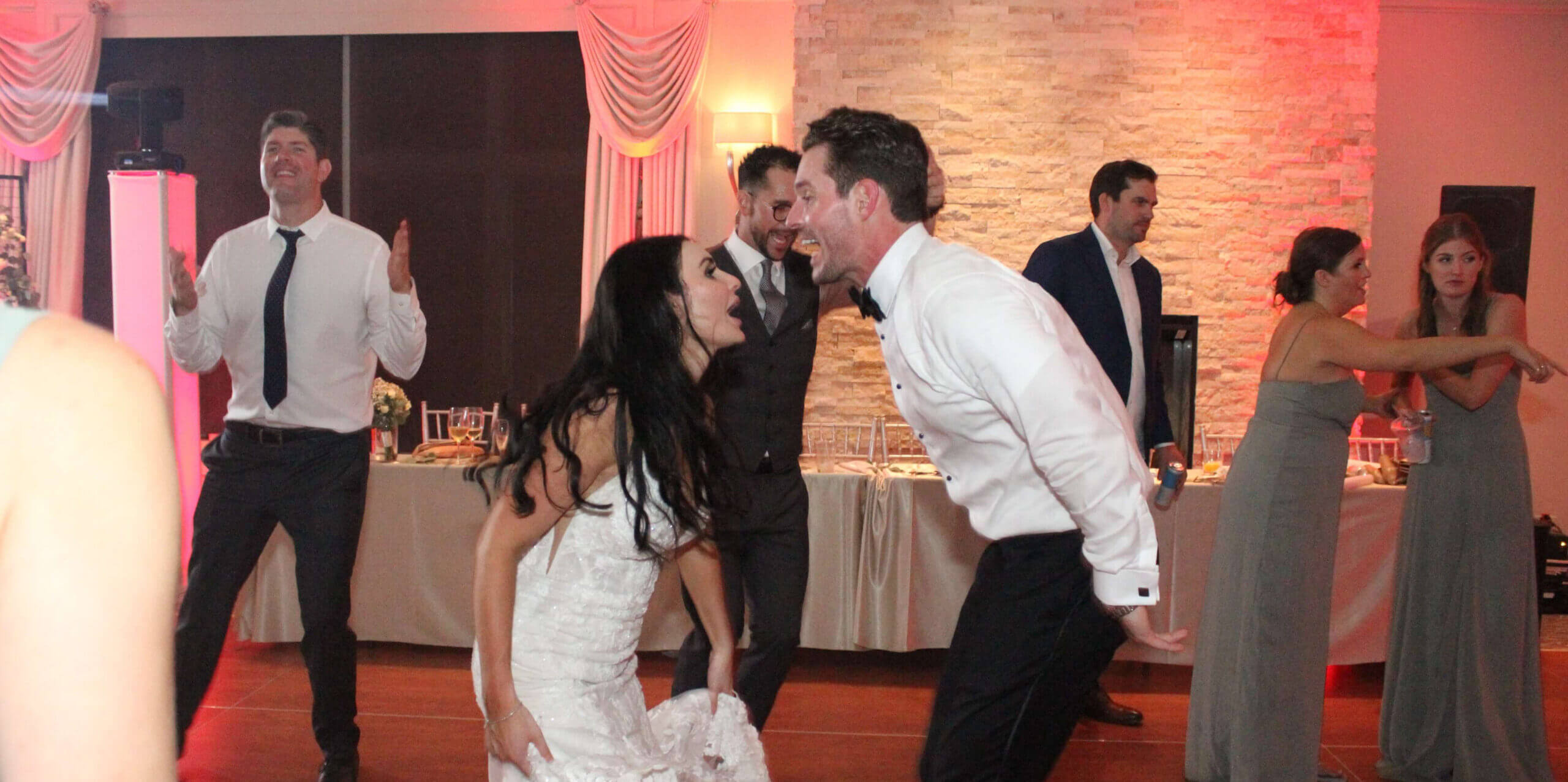 Bride and groom shouting to each other on the dance floor, dancing and singing along to music by Paul Michaels Events DJ Company, the best wedding DJ in Chicagoland