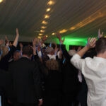 Photo of people on the dance floor with their hands in the air, dancing to music by Paul Michaels Events, a Chicago Suburbs Wedding DJ