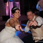 Bride and groom striking a pose to the camera while dancing to the best Chicago suburbs wedding DJ at DoubleTree Hilton Hotel Chicago in Skokie, Illinois