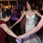 Bride dancing with female family members to music by a Chicago DJ for Downtown Wedding, Paul Michaels Events