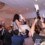 Bride and groom doing the traditional Horah dance with their guests, with expert DJ services provided by Paul Michaels Events