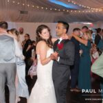 Bride and groom dancing in the middle of their dance floor with other couples dancing around them, with renowned wedding DJ services by Paul Michaels Events being provided