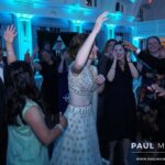 Bride and groom surrounded by loved ones on the dance floor, dancing the night away to the best Evanston DJ entertainment services, courtesy of Paul Michaels Events