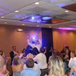 Group of people surrounding guest of honor at bar mitzvah, with bar mitzvah entertainment services provided by Paul Michaels Events