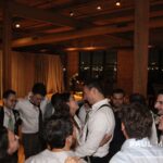 Bride and groom standing in a circle of their loved ones on the dance floor, swaying to the sounds of Paul Michaels Events, a premier Chicago DJ company