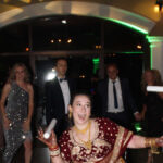 A bride in the middle of the dance floor surrounded by dancing guests and light up foam sticks, courtesy of Paul Michaels Events, a Premier Chicagoland DJ Company