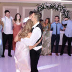 Bride and groom surrounded by friends and family at their wedding