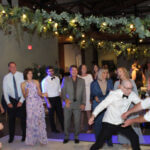 A group of wedding guests dancing on the floor