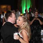 Bride & groom on dance floor surrounded by loved ones