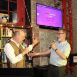 Two gentlemen singing karaoke at Kibbitznest in Chicago's