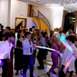 Group of people with glow sticks on the dance floor
