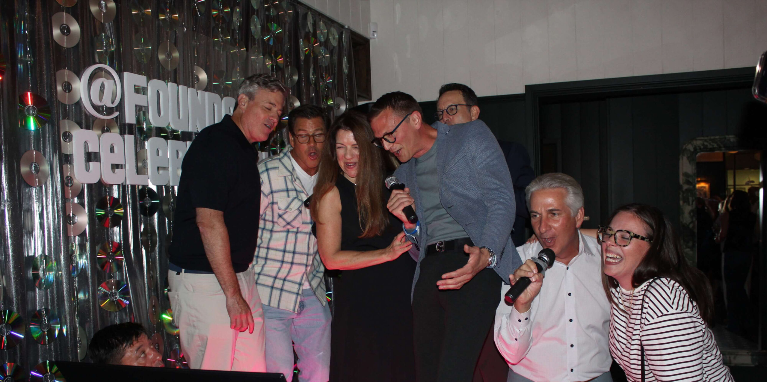Group of people singing karaoke with music a