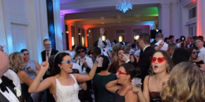 Bride with friends posing at photo booth at Chicago History Museum with music provided by Paul Michaels Events